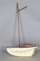 A mid-20th century pond yacht with faux planked deck and painted hull, length 87cm.Buyer’s Premium