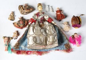 A Queen Victoria Coronation wooden peg doll with painted features, wearing a gilded crown, earrings,