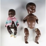 An Armand Marseille composition black baby doll, height 35cm, and a similar doll, height 26cm (