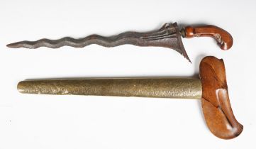 An Indonesian kris dagger with wavy double-edged blade, blade length 34cm, detailed with sinuous