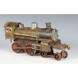 A gauge O clockwork 4-4-0 locomotive, possibly German, in green and black red-lined livery (rust,