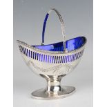 A George III silver oval sugar basket with beaded swing handle above pierced and engraved foliate