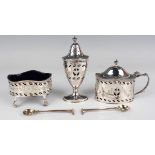 An Elizabeth II silver three-piece condiment set of oval form, pierced and engraved with foliate