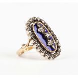 A Continental gold and silver set, blue enamelled and diamond oval panel shaped ring, the central