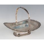 A George III silver oval cake basket with cast foliate and reeded swing handle above a cast floral