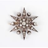 A Victorian gold backed, silver set and diamond brooch, designed as a starburst, mounted with