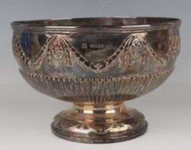 A Victorian silver circular half-reeded rose bowl, embossed with floral medallions united by foliate