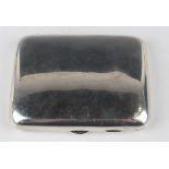 A late Victorian silver cigarette case of plain curved rectangular form with rounded corners,