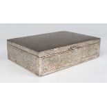 An Egyptian silver rectangular box, the hinged lid and sides engraved with panels of script,