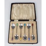 A set of six Art Deco silver and enamelled coffee spoons, each terminal decorated in a different