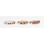 A 9ct gold, ruby and diamond ring, mounted with five marquise shaped rubies and four circular cut
