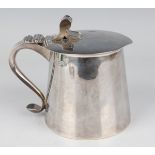 A George V silver lidded tankard of tapering cylindrical form, the hinged lid with scroll thumbpiece