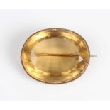 A Victorian gold mounted citrine single stone oval brooch, unmarked, weight 25.1g, width 3.9cm.