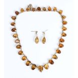 A silver gilt and citrine rivière necklace, mounted with a graduated row of oval cut citrines, on
