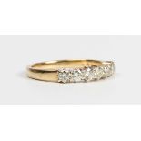 An 18ct gold and diamond seven stone half hoop ring, claw set with a row of circular cut diamonds,