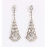 A pair of diamond pendant earrings in a tapered pierced geometric design, with post and butterfly