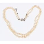 A two row necklace of graduated cultured pearls on a rose cut diamond set oval clasp, length of