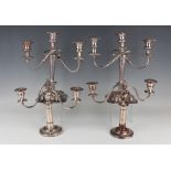 A pair of plated-on-copper three-light twin scroll branch candelabra, each with square detachable