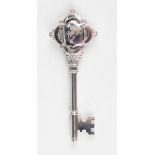 A George V silver presentation key, the central shield shaped cartouche name and date engraved