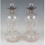 A pair of George V silver mounted clear glass 'cluck-cluck' decanters and stoppers, each silver