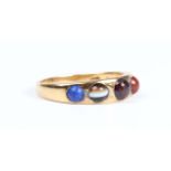 A Victorian gold ring, mounted with a row of five graduated varicoloured cabochon gemstones,