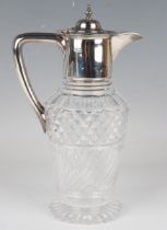 An Edwardian silver mounted cut glass claret jug, the domed hinged lid with knop finial above a