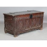 A late 17th century oak coffer, the hinged lid with strap hinges and carved front, height 65cm,