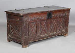 A late 17th century oak coffer, the hinged lid with strap hinges and carved front, height 65cm,