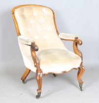 A mid-Victorian walnut showframe open armchair, raised on carved cabriole legs, height 93cm, width