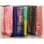 A quantity of Indian silk saris and other related fabrics, some with woven gilt edging.Buyer’s
