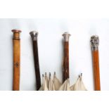 A Victorian silver topped rosewood walking cane, length 89cm, two further walking canes and a