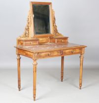 An early 20th century French walnut dressing table with carved leaf decoration, inset with a rouge