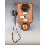 An early 20th century oak cased wall telephone, possibly from a railway, the front with applied