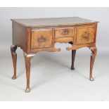An 18th century oak lowboy, the crossbanded top above three drawers, on cabriole legs and pad