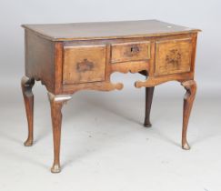 An 18th century oak lowboy, the crossbanded top above three drawers, on cabriole legs and pad