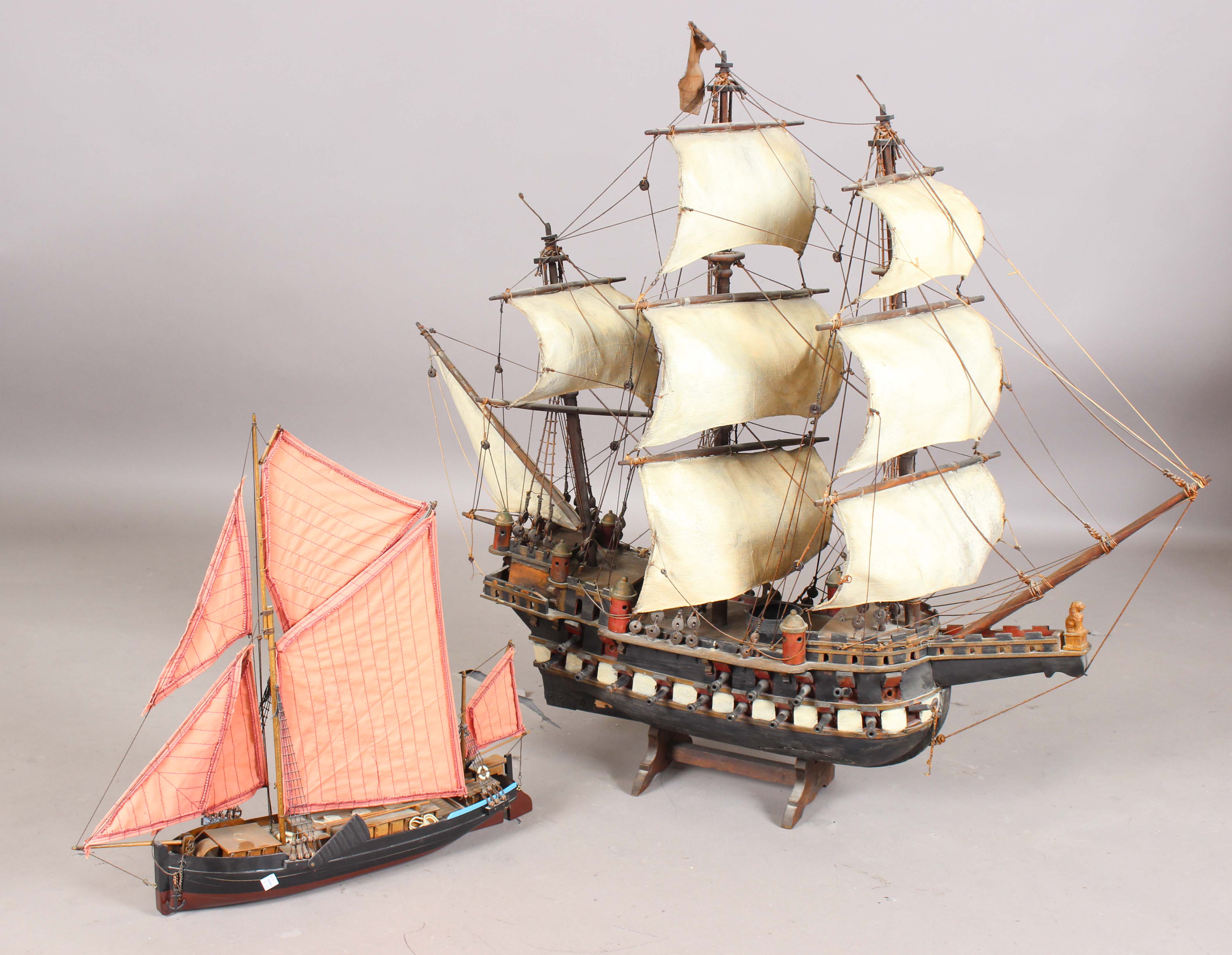 A 20th century scratch-built wooden model of a galleon, length 110cm, together with a model of a