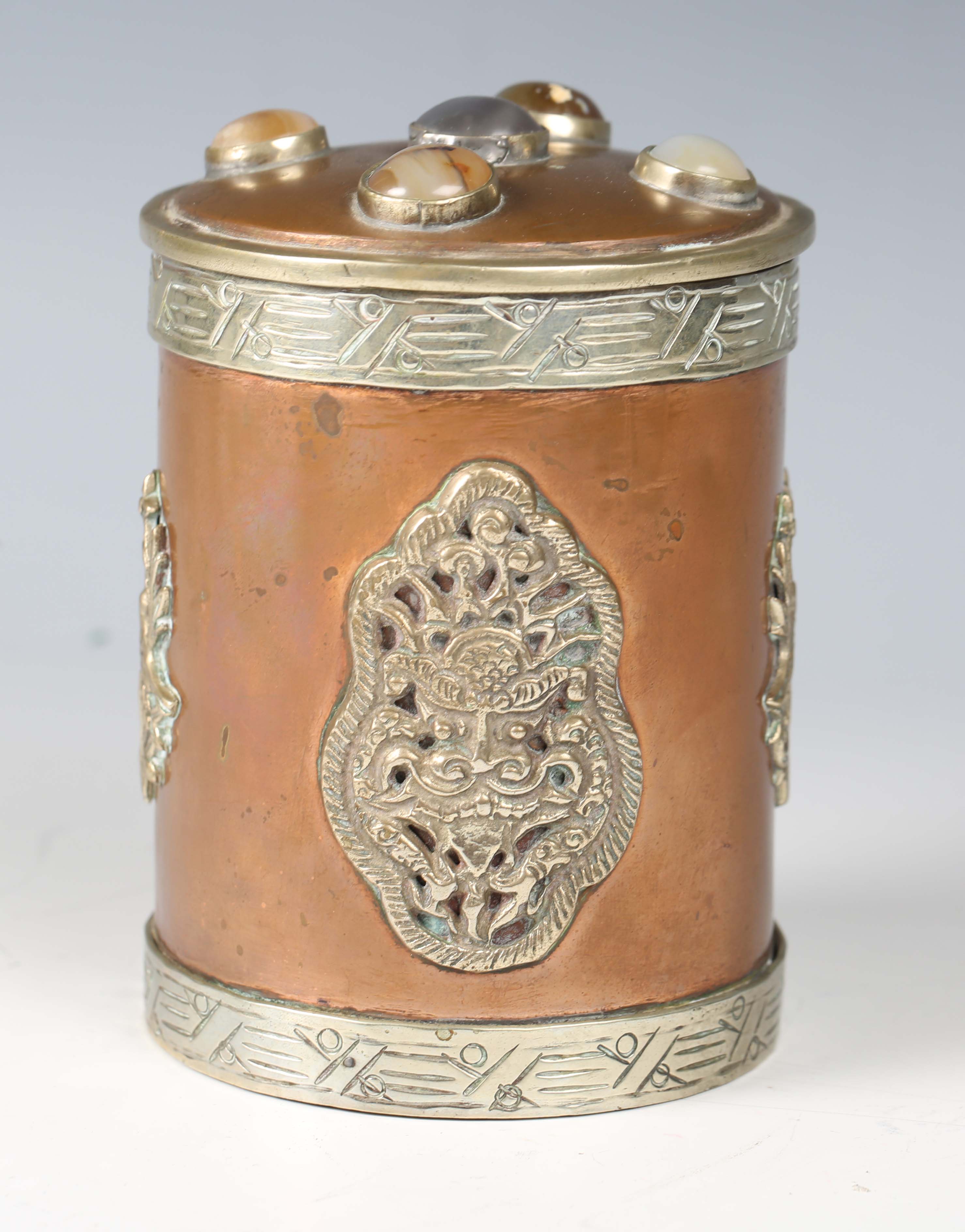 A 20th century Tibetan copper and nickel mounted cylindrical jar and cover, the lid inset with - Image 7 of 8