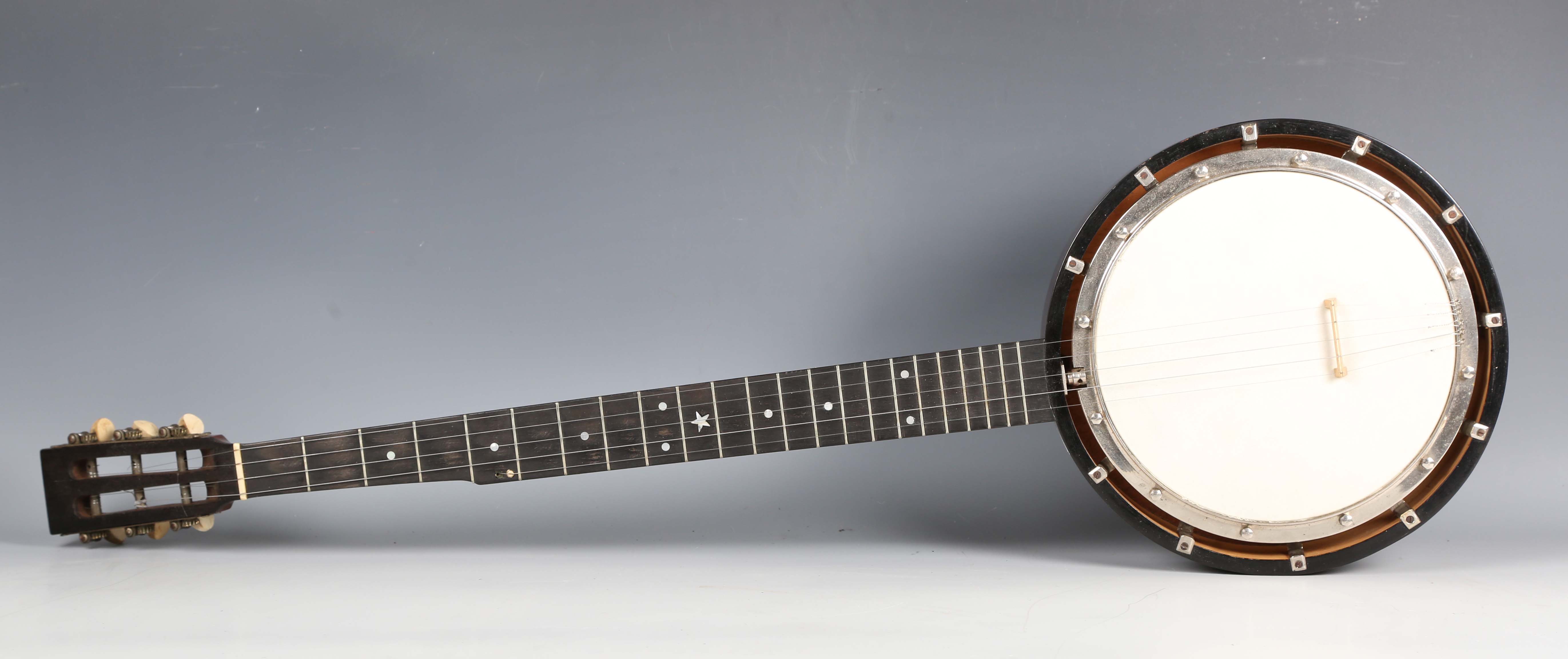 An early 20th century five-string banjo by Butler, Haymarket, London, length 90cm, cased.Buyer’s
