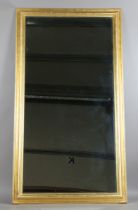 A large 19th century rectangular wall mirror with a later gilded moulded section frame and