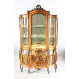 A late 19th/early 20th century Louis XV style vitrine of bombé form with brass mounts and vernis