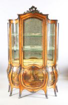 A late 19th/early 20th century Louis XV style vitrine of bombé form with brass mounts and vernis