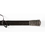 An 18th century ebony and white metal mounted walking stick, the pommel with foliate engraved and