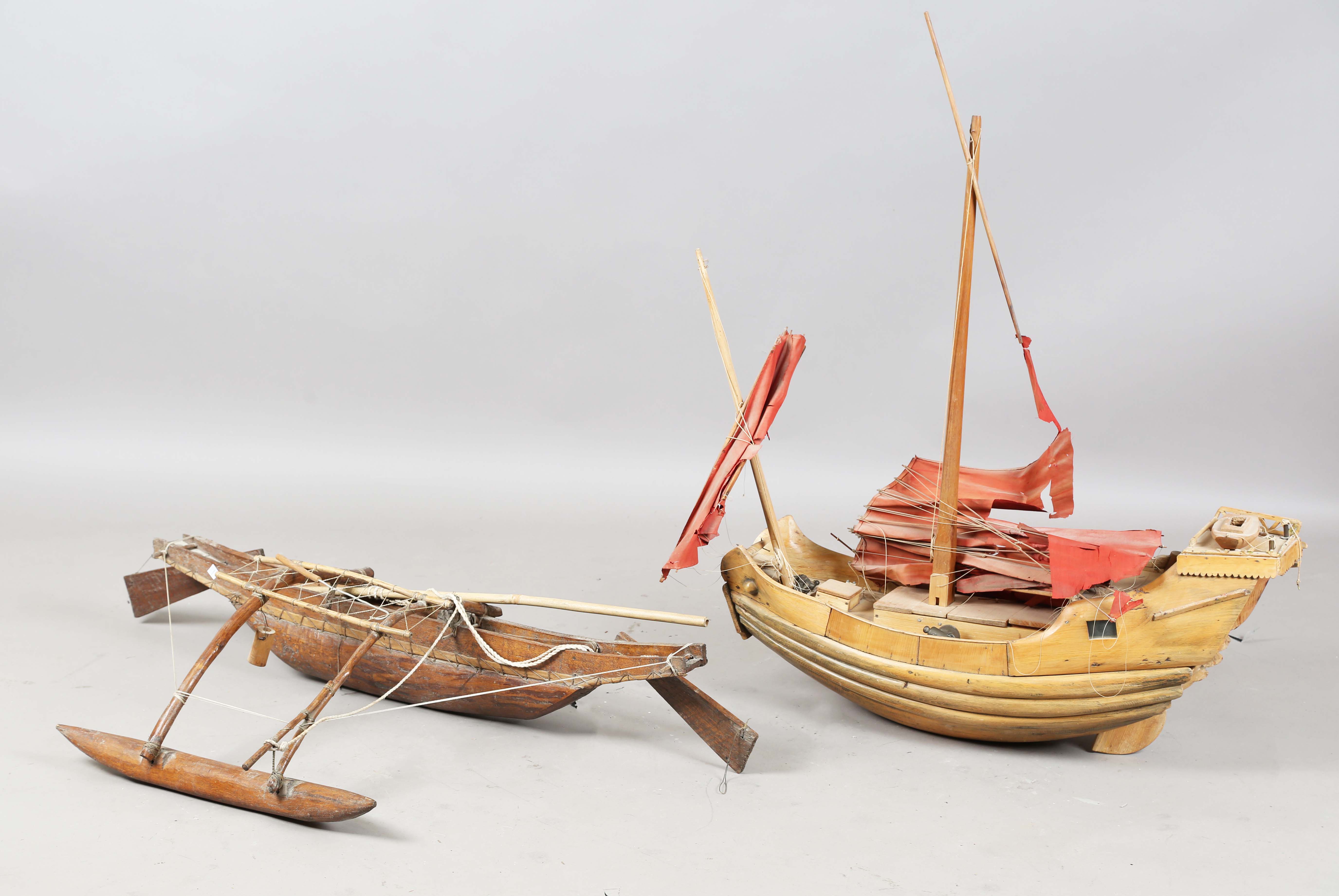 An early 20th century scratch-built softwood model of a boat, detailed with two brass cannons and