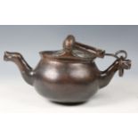 A 16th century Flemish patinated bronze lavabo, the swing handle above two female mask lugs, the