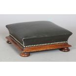 A Victorian mahogany footstool, upholstered in dark green leather, height 14cm, width 34cm.Buyer’s