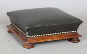 A Victorian mahogany footstool, upholstered in dark green leather, height 14cm, width 34cm.Buyer’s