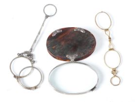 An early 19th century tortoiseshell and silver mounted oval magnifying lens, length 8cm, together