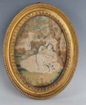 A Regency oval silkwork panel, worked with a girl reclining against a tree in a garden, 19cm x 14cm,