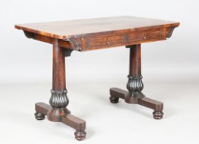 A Regency rosewood library table, fitted with two oak-lined drawers opposing dummy drawers, raised