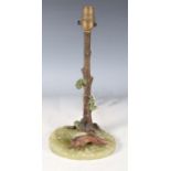 An early 20th century Austrian cold painted bronze table lamp depicting a fox beneath a tree on a